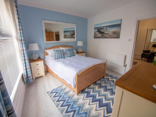 a bedroom with a bed and a table and a desk at North Bay Holiday Apartment with Internet, Smart TV's and Patio Area in Scarborough