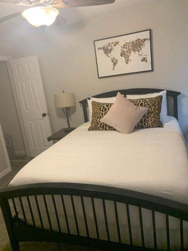 a bedroom with a bed with pillows and a map on the wall at Superb For Traveling Workers Near Cartersville MC in Cartersville
