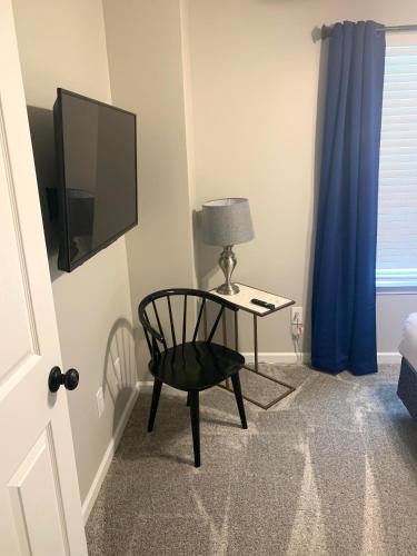 a room with a chair and a table with a television at Superb For Traveling Workers Near Cartersville MC in Cartersville