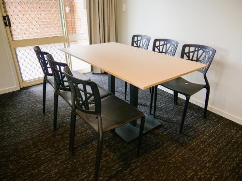 a conference room with a table and chairs at Nightcap at Hinterland Hotel Nerang in Gold Coast