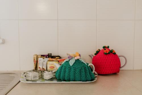 a kitchen counter with two crocheted items on a counter at Inverell Terrace Motor Lodge in Inverell