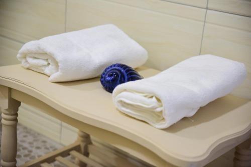 two towels sitting on a table in a bathroom at Casa Rosa in Flic-en-Flac