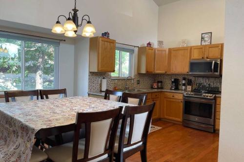 a kitchen with a dining room table with chairs and a tableablish at 2 Master Suites/3 King Beds/4 Bath/Mins to Airport in Colorado Springs