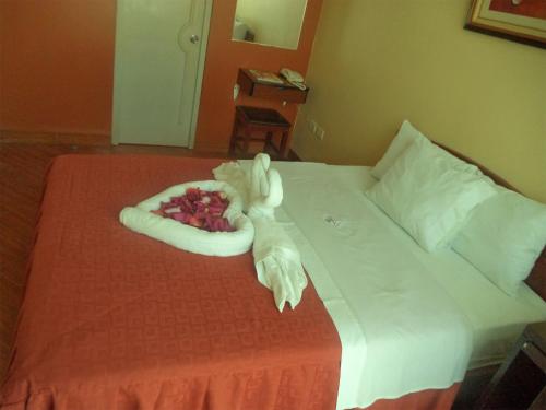 a hotel room with a bed with a towel on it at Hotel Primavera in Chiclayo
