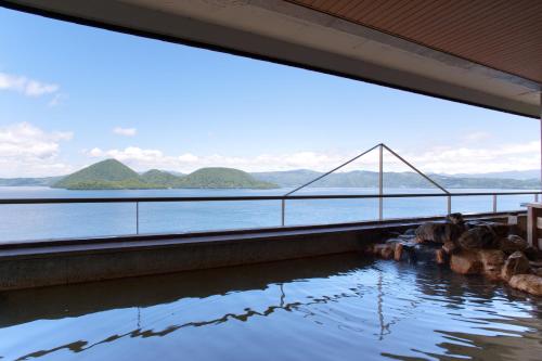 a view of a bridge over a body of water at Toya Kohan Tei in Lake Toya