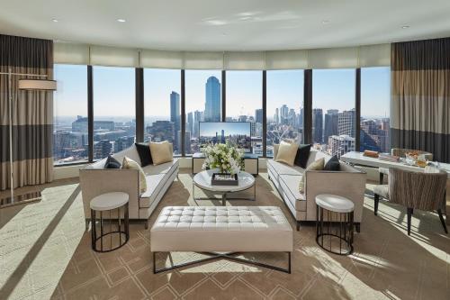 a living room with a view of a city at Crown Towers Melbourne in Melbourne