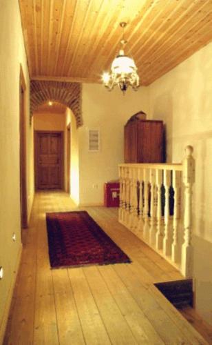 a hallway of a house with a staircase and a chandelier at Nimbus Guesthouse in Kastoria