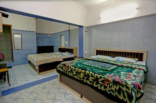 a bedroom with two beds in a room at The Trekkers Hostel - Dehradun in Dehradun