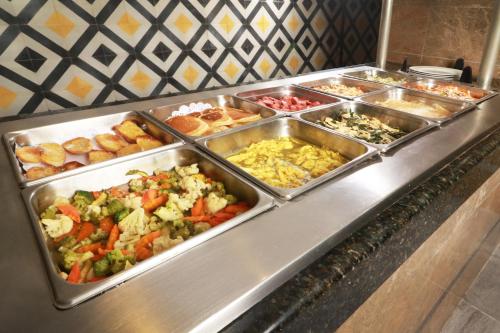 a buffet line with many different types of food at Holiday Inn Hotel & Suites Centro Historico by IHG in Guadalajara