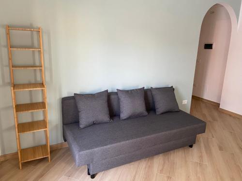 a gray couch in a room with a shelf at Monte Roraima in Scalea