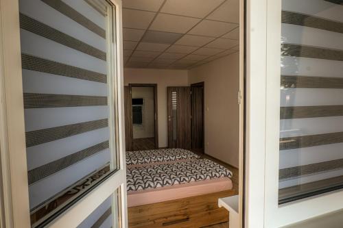 a small bedroom with a bed in a room at Apartmany Motocentrum in Kaluža