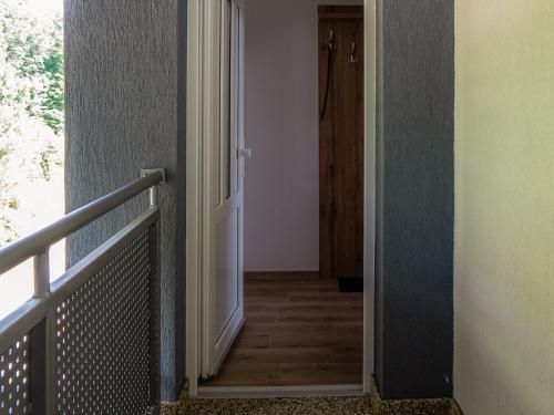 a hallway with an open door to a room at Apartmany Motocentrum in Kaluža