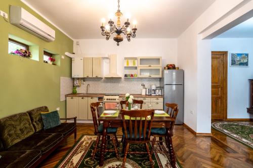 a kitchen and living room with a table and a couch at Unique Old Town Home 2min to Beach and Harbour Private Entrance in Constanţa
