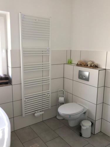 a white bathroom with a toilet and a sink at Apartment Perla in Limburg an der Lahn