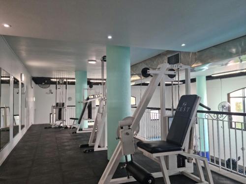 a gym with several tread machines in a room at Island Club by Smart City Stays in Cape Town