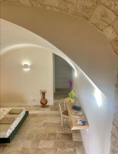a bedroom with a bed and a table in a room at B&B re apartments Palazzo Muscati in Molfetta