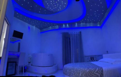 a blue room with a bed and a moon at B&B Vittorio Emanuele in Licata