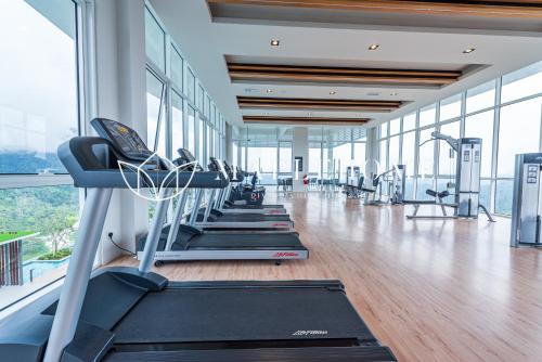 a gym with a row of treadmills and machines at Windmill Premier Suites Genting Highlands in Genting Highlands