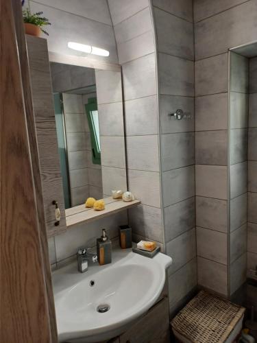 a bathroom with a sink and a mirror at Lolos' house in Rhodes Town
