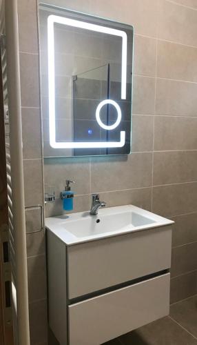 a bathroom with a sink and a mirror at Check-In Kaya in Sibiu