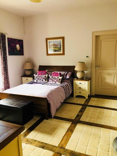 a bedroom with a bed and two night stands with lamps at The Old Flax Mill Yoga Retreat in Coleraine