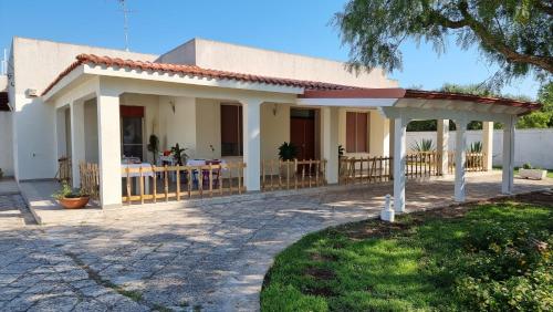 a house with a porch and a patio at Villa Vittoria in Mesagne