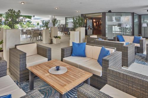 a patio with wicker chairs and a table at Best Western Hotel Trier City in Trier