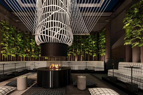 a rendering of a lobby with a fire pit at The Londoner in London