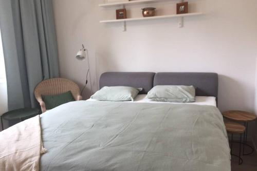 a bedroom with a bed and a table and a chair at A Cozy Studio in the City Centre in Bratislava
