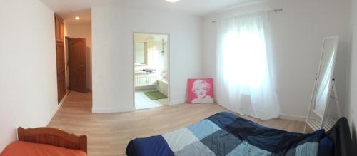 a bedroom with a bed in a room with a window at Maison calme avec grand jardin en Sologne in Chaumont-sur-Tharonne