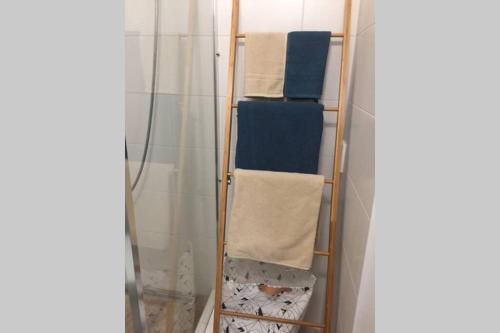 a towel rack with towels on it in a bathroom at A Cozy Studio in the City Centre in Bratislava