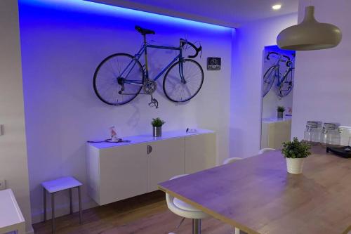 a bike hanging on a wall in a room with a table at MAMI / Apto 5 in San Sebastián de la Gomera