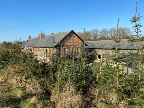 an old house on top of a hill at The Old Flax Mill Yoga Retreat in Coleraine