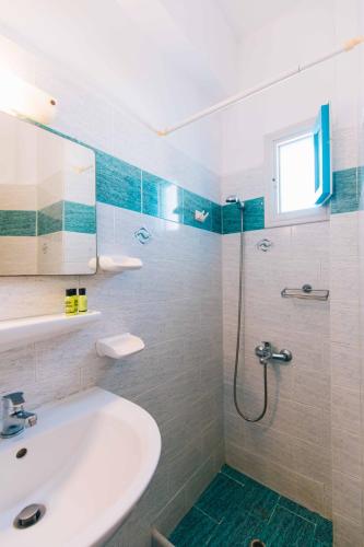 a bathroom with a sink and a shower at Kafieris View in Firostefani