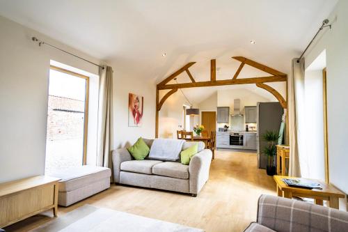 a living room with a couch and a table at Brecks Farm - The Tractor Shed in York