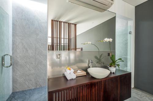 a bathroom with a sink and a mirror at PANDAWA VILLAS SEMINYAK in Seminyak
