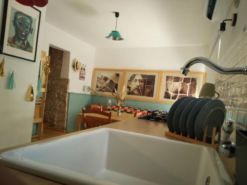 a kitchen with a white sink and a table at La finestra sul cortile in Atri