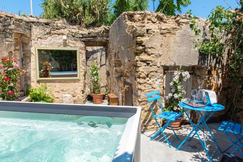 un patio trasero con piscina, mesa y sillas en Albergo Rurale Casa Fois, en Valledoria