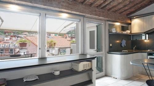 a kitchen with a window with a view of a city at Cala D'Oria in Lerici