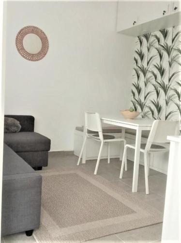 a living room with a white table and chairs at Erdei Apartman Hajdúszoboszló in Hajdúszoboszló