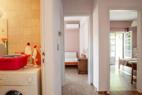a kitchen with a washing machine and a room at Rena's Hospitality walk to the beach,10min to Chania! in Kato Daratso