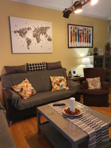 a living room with a couch and a table at JÁNDALA in Unquera