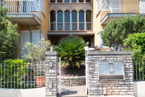 a gate in front of a house with a building at Sirmio Apartments - Narnia Stay in Sirmione