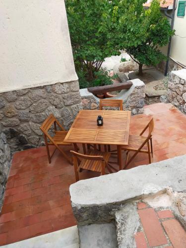 a wooden table and chairs on a patio at CASA SAN ROCCO in Porto Ercole