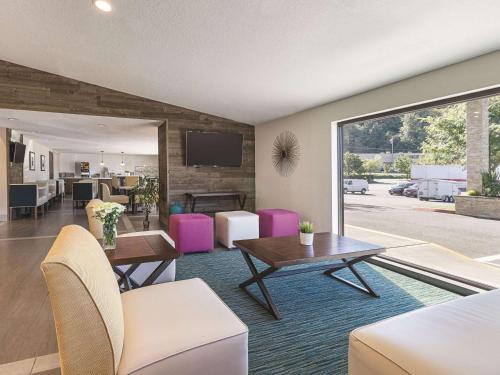 a living room with a couch and a table at La Quinta by Wyndham Portland NW in Portland