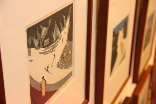 a picture of a man on a wall with grapes at Hakuba Skala Inn in Hakuba