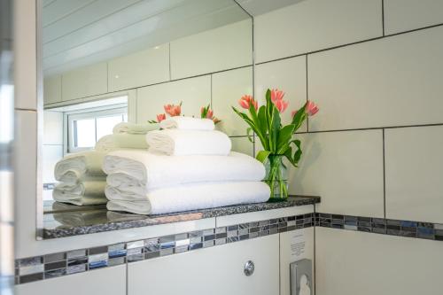 a stack of towels on a counter in a bathroom at Brecks Farm - Well Cottage in York