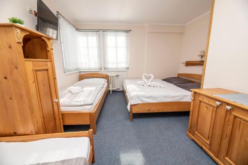 a room with three beds in a room at penzion Vysoká Stráž in Pec pod Sněžkou