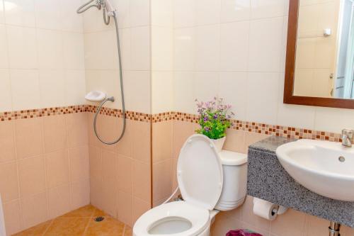 a bathroom with a toilet and a sink at K.V.Mansion in Bangkok