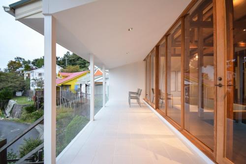 an internal corridor of a house with glass doors and a balcony at Awaji Villa Forest - Vacation STAY 44333v in Awaji